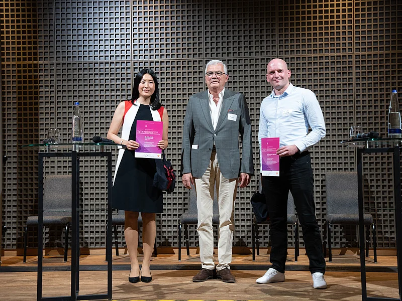 Prof. Meurer (Mitte) ehrt Dr. Sarah Kim-Hellmuth und Dr. Konstantin Sparrer 