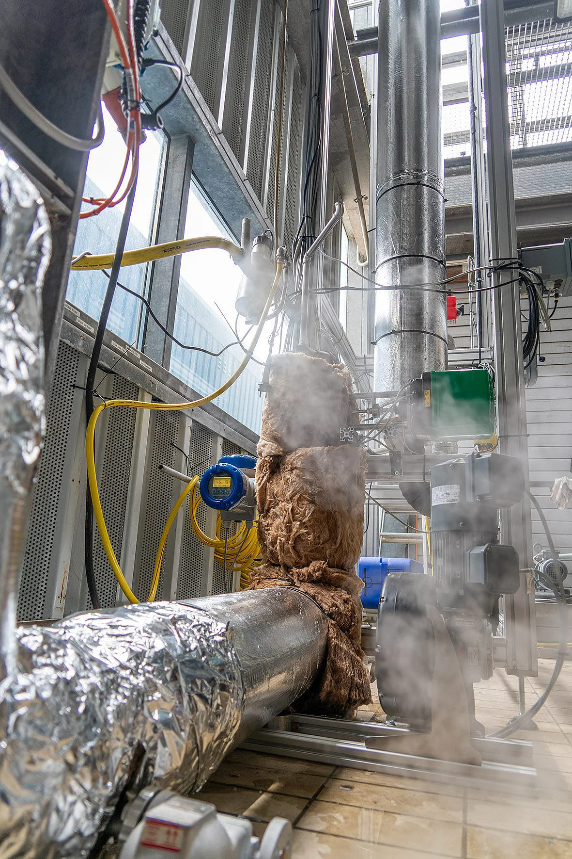 A stripping column from which steam is escaping
