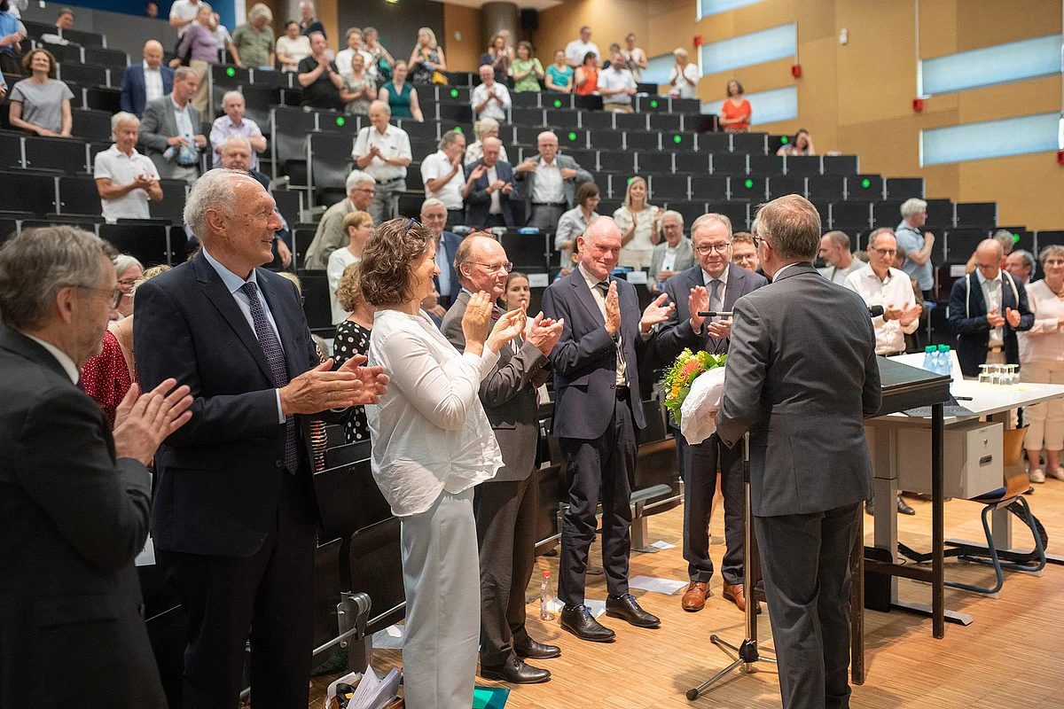 A lecture theatre full of people applauding