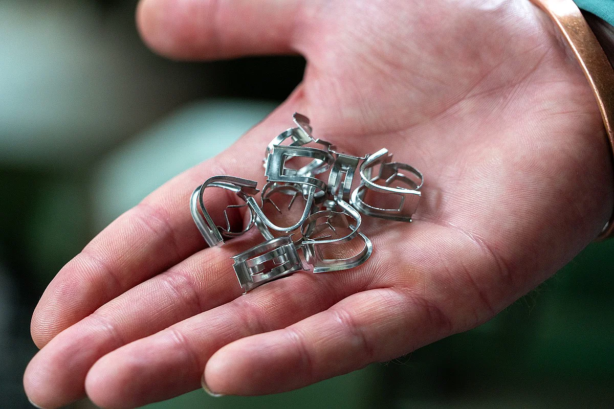 Close-up of small metal parts in the palm of a hand