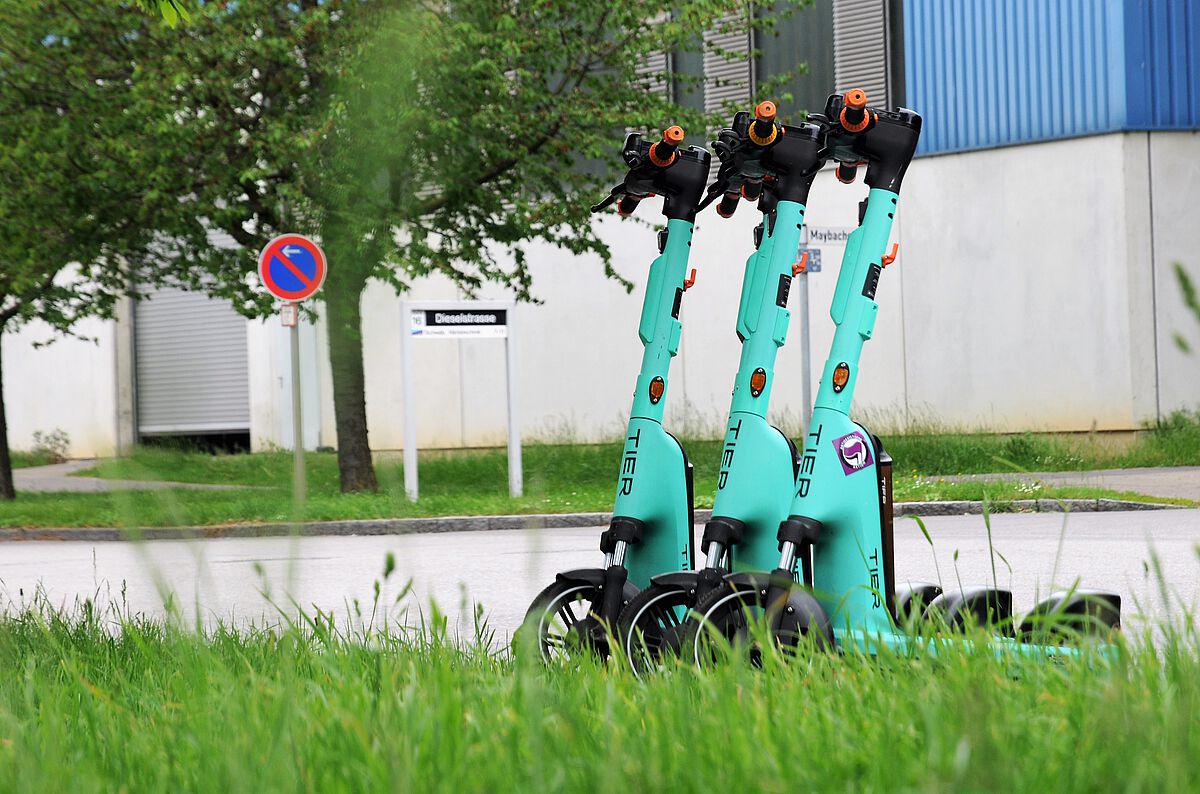 Drei E-Scooter stehen im Industriegebiet Donautal nebeneinander