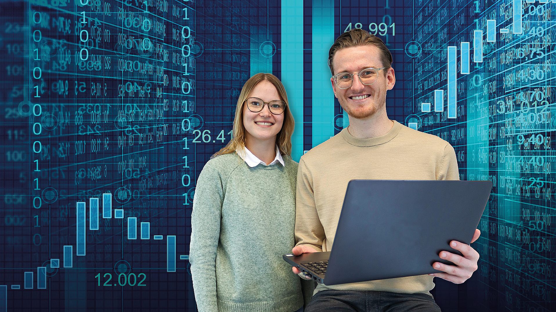 Management Information Systems: A student and a student stand at a laptop