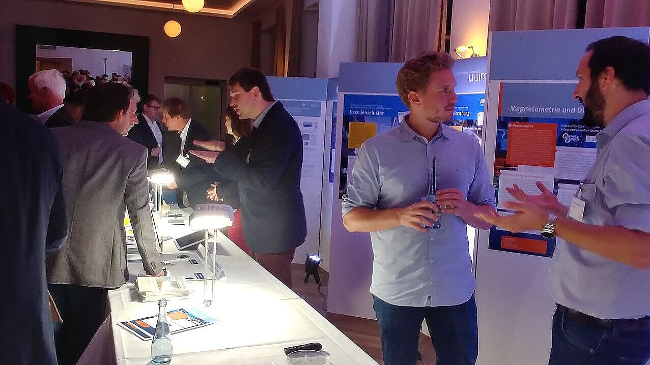 Technology transfer Engineers talking to attendants at a convention