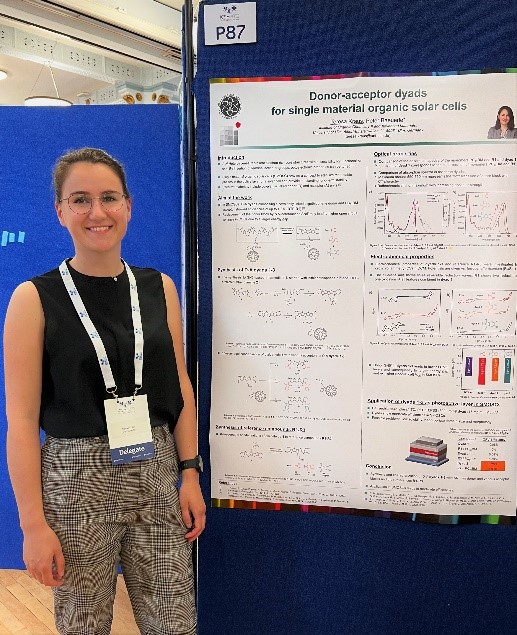 PhD student Teresa Kraus at her poster with the title „Donor-acceptor dyads for single material organic solar cells“.