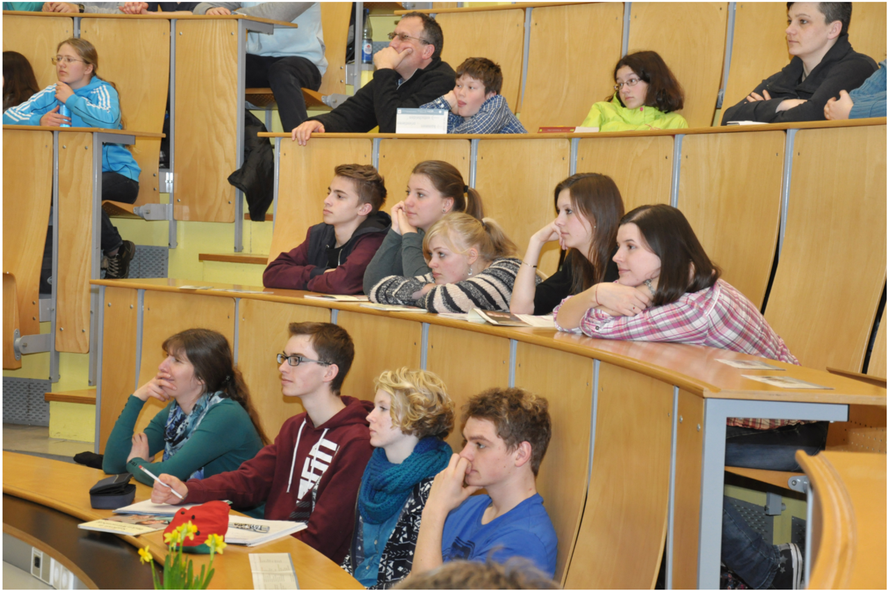 A group of students are sitting in the lecture hall.